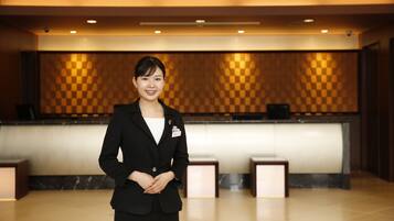 A reception area with a checkered wall, a reception desk, and a modern interior design.