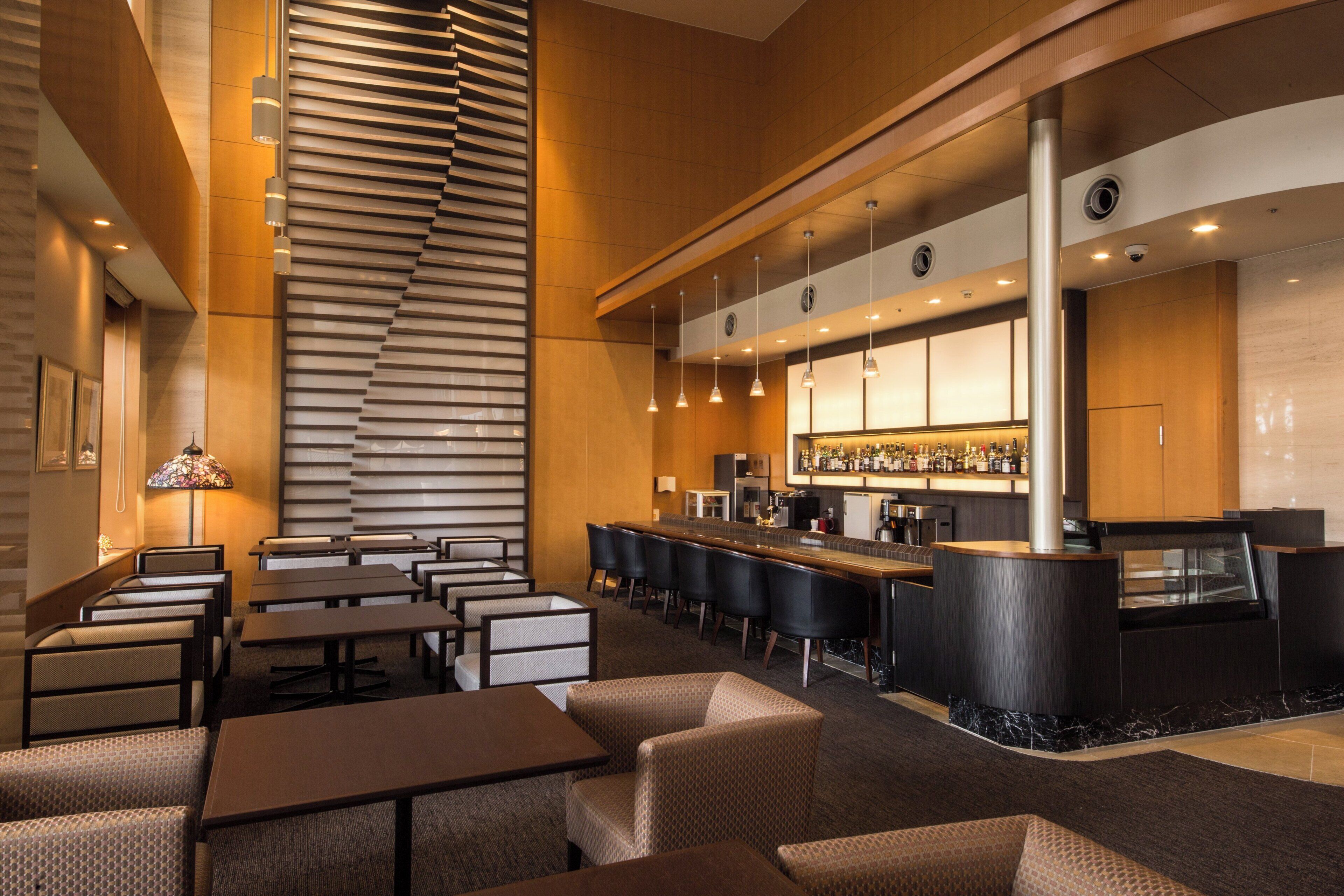 A modern bar area with seating and a bar counter.