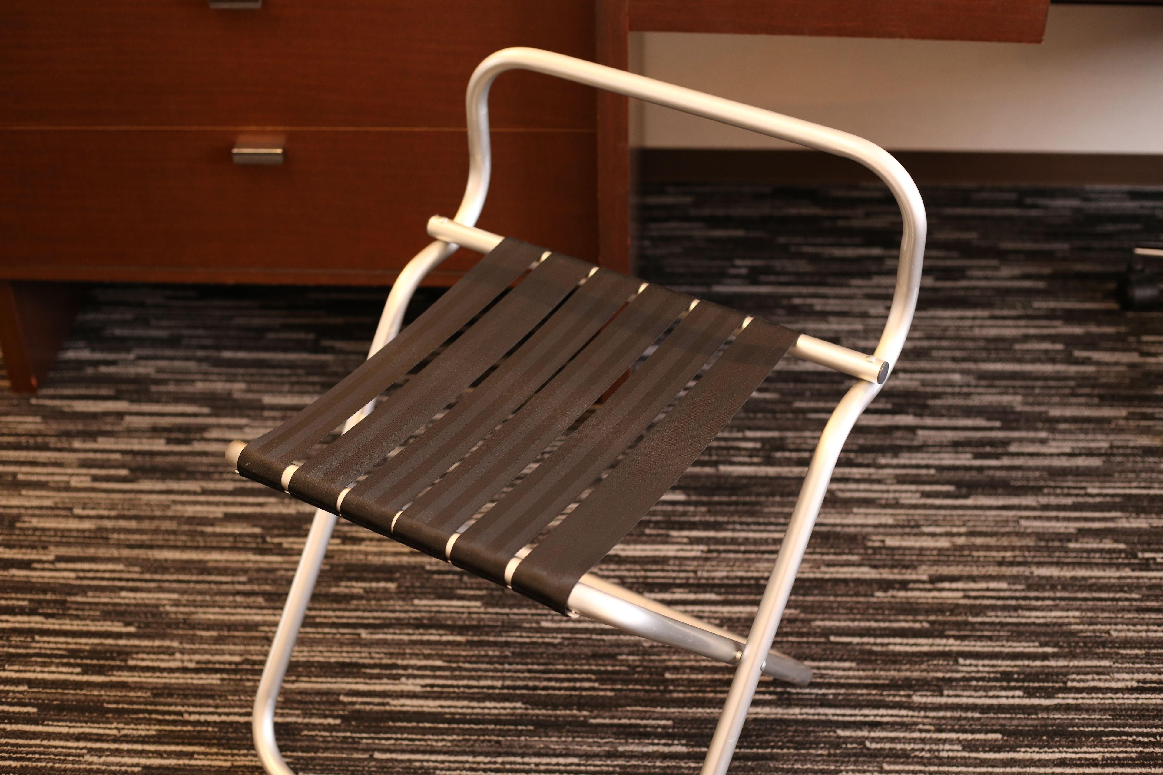 A chair with a metal frame and a dark seat.