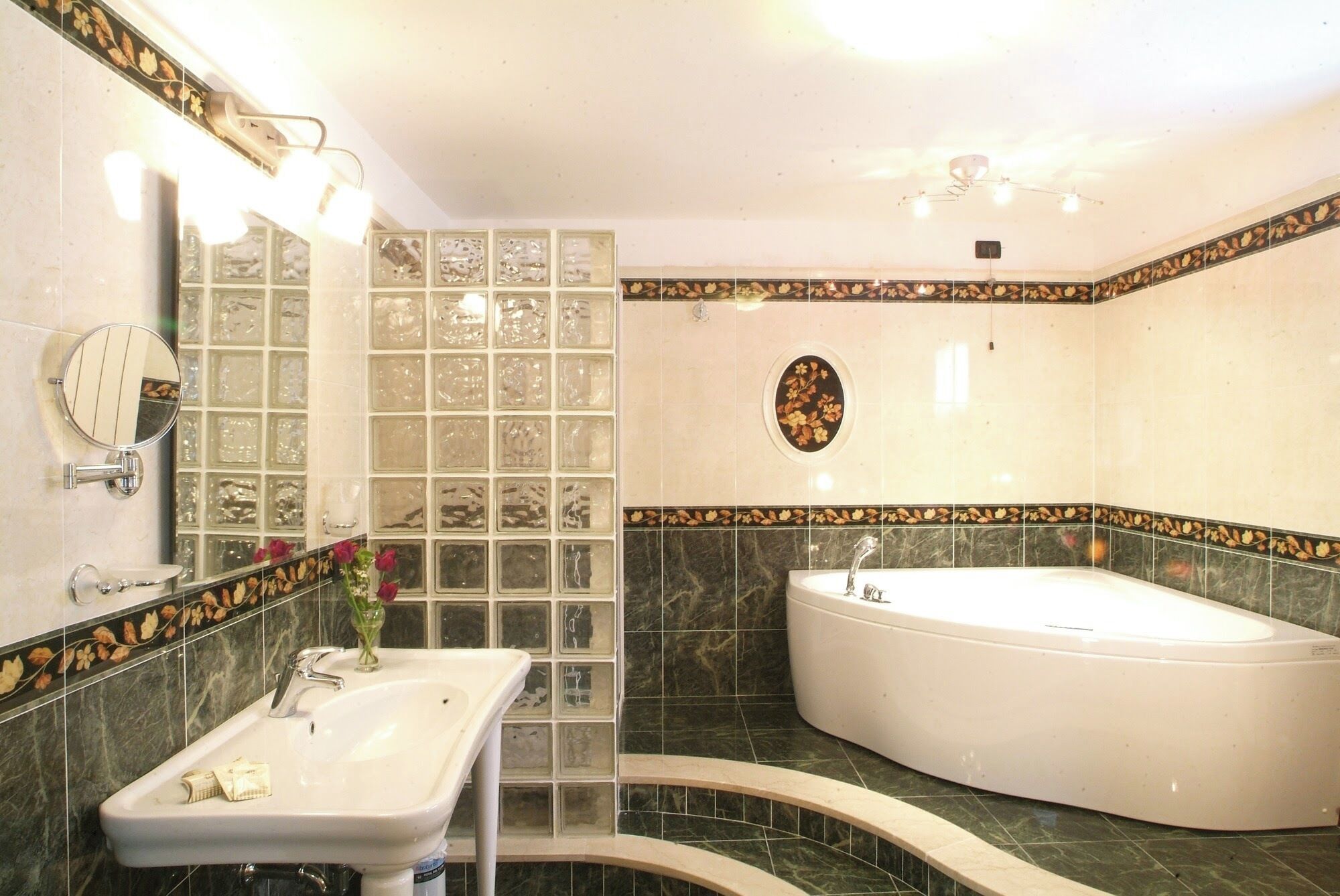 A bathroom with a sink, mirror, and bathtub.