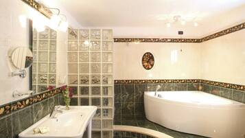 A bathroom with a sink, mirror, and bathtub.
