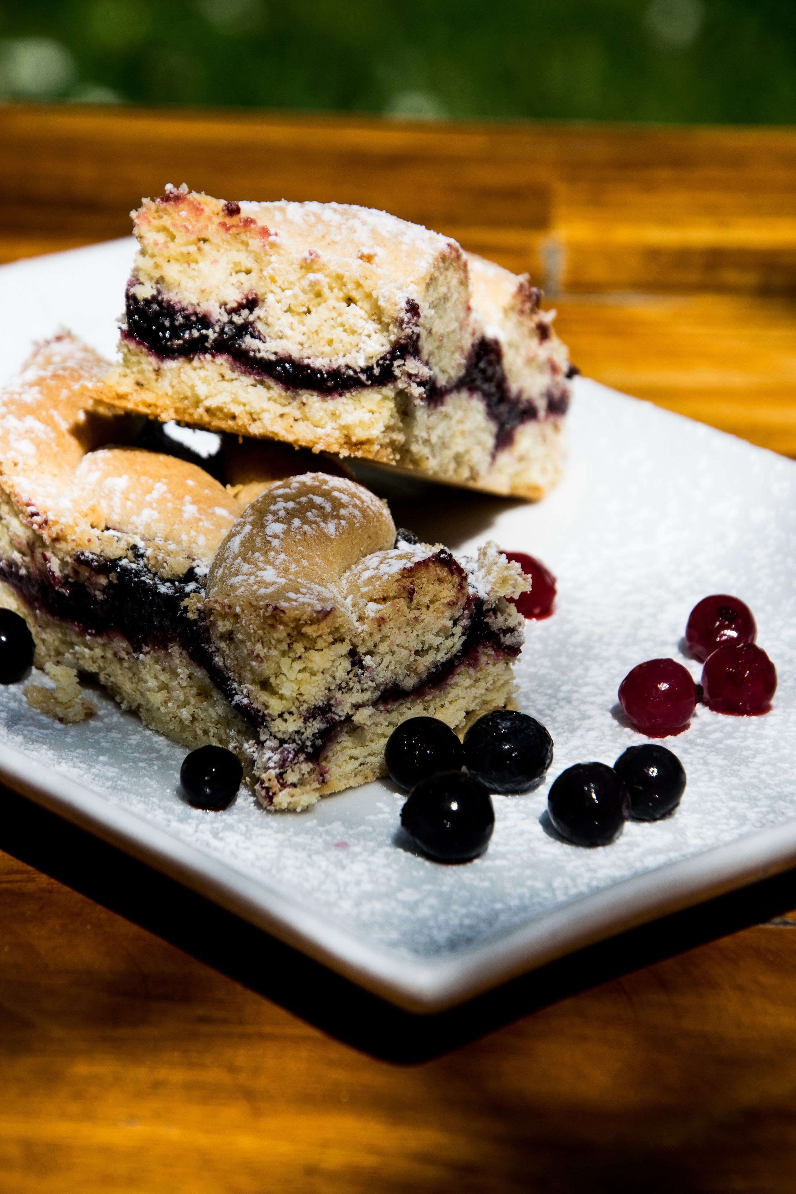 A dessert plate with a slice of cake and berries.