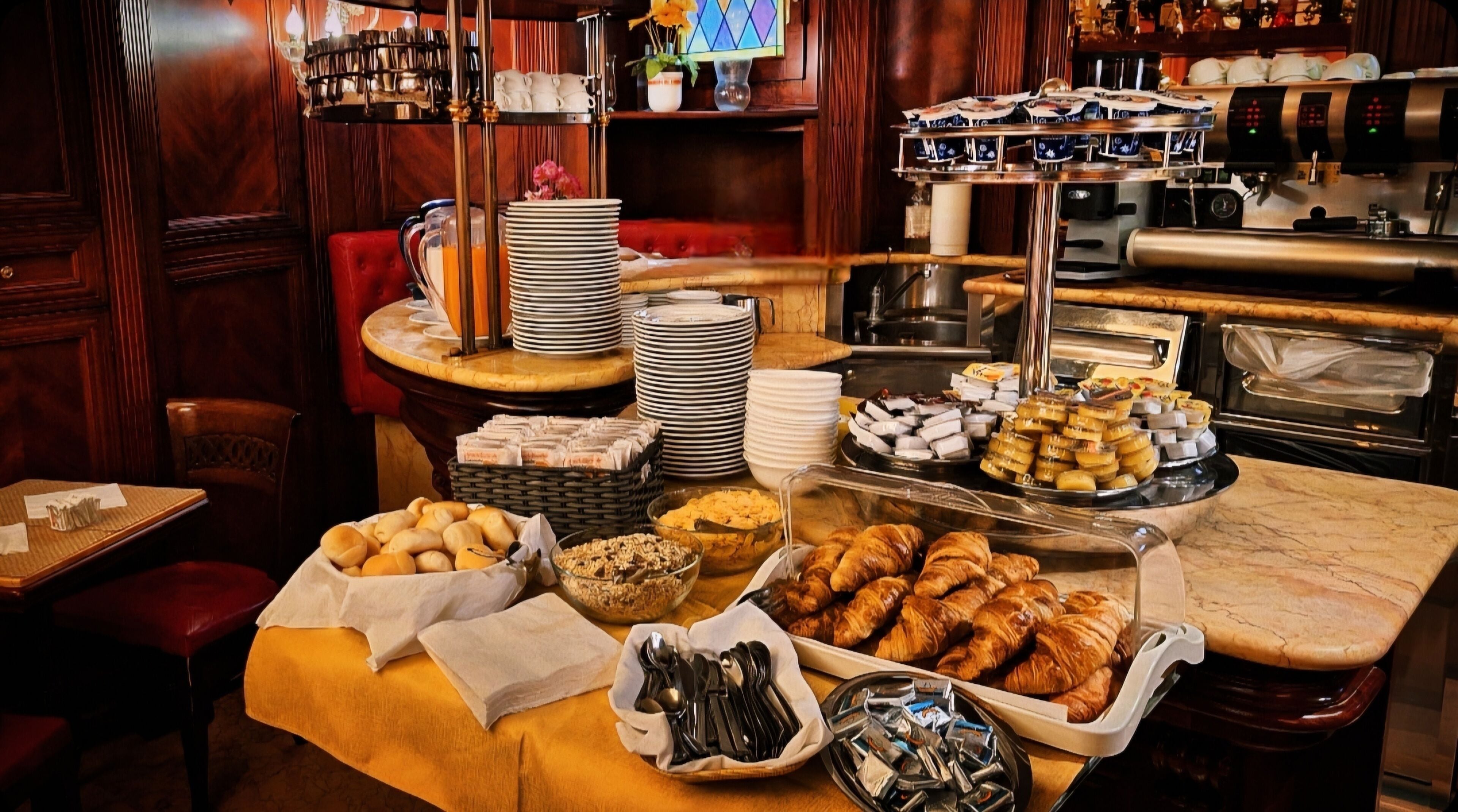 A buffet setup with various food items and a coffee machine.