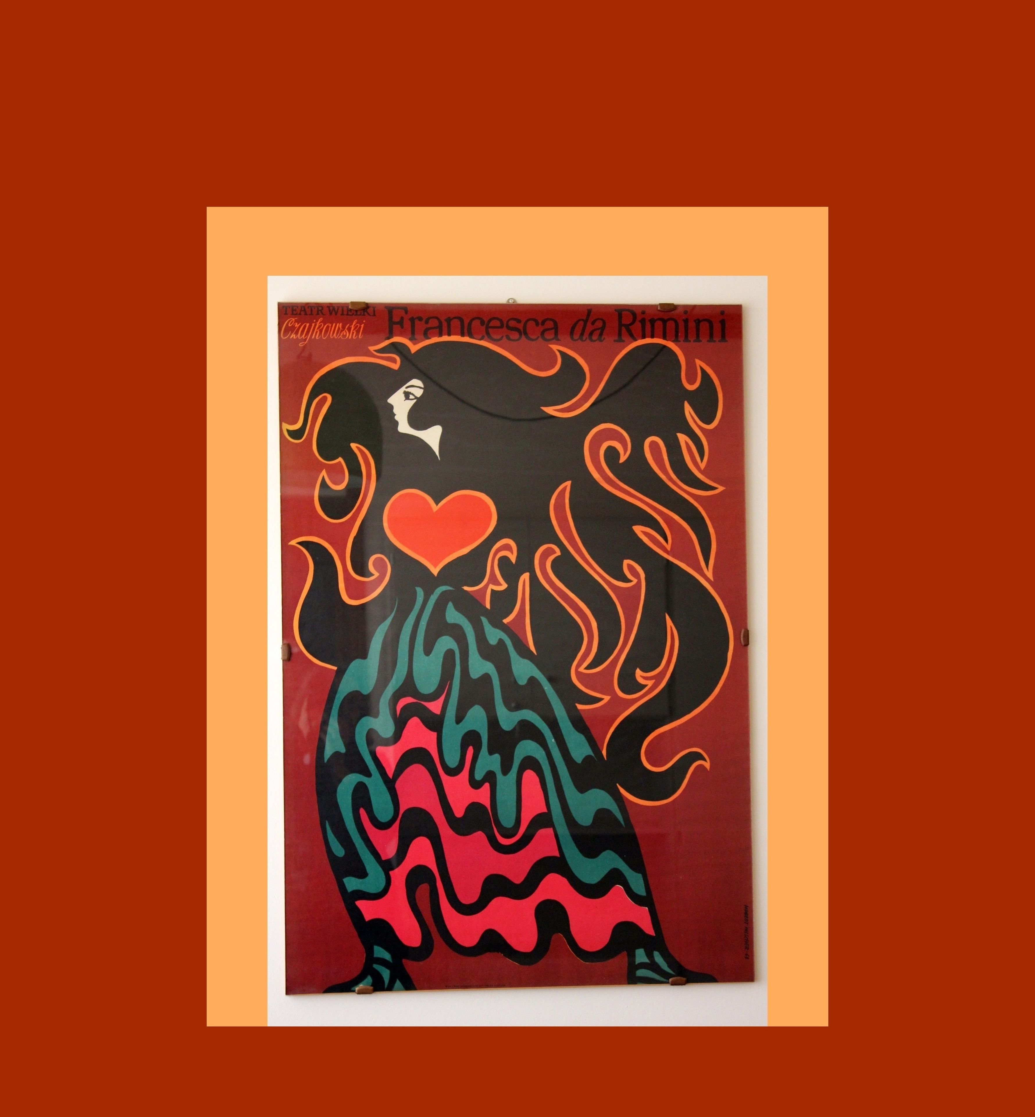 A framed artwork of a woman with flowing hair and a heart, titled "Francesca da Rimini" by Teatr Wielki.
