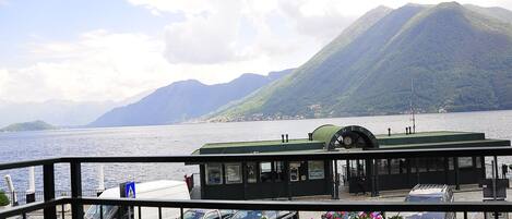 A ferry terminal with a view of a lake and mountains.