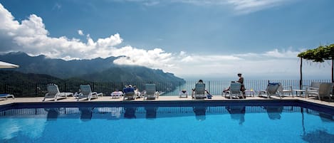 Seasonal outdoor pool, open 9:00 AM to 6:00 PM, sun loungers