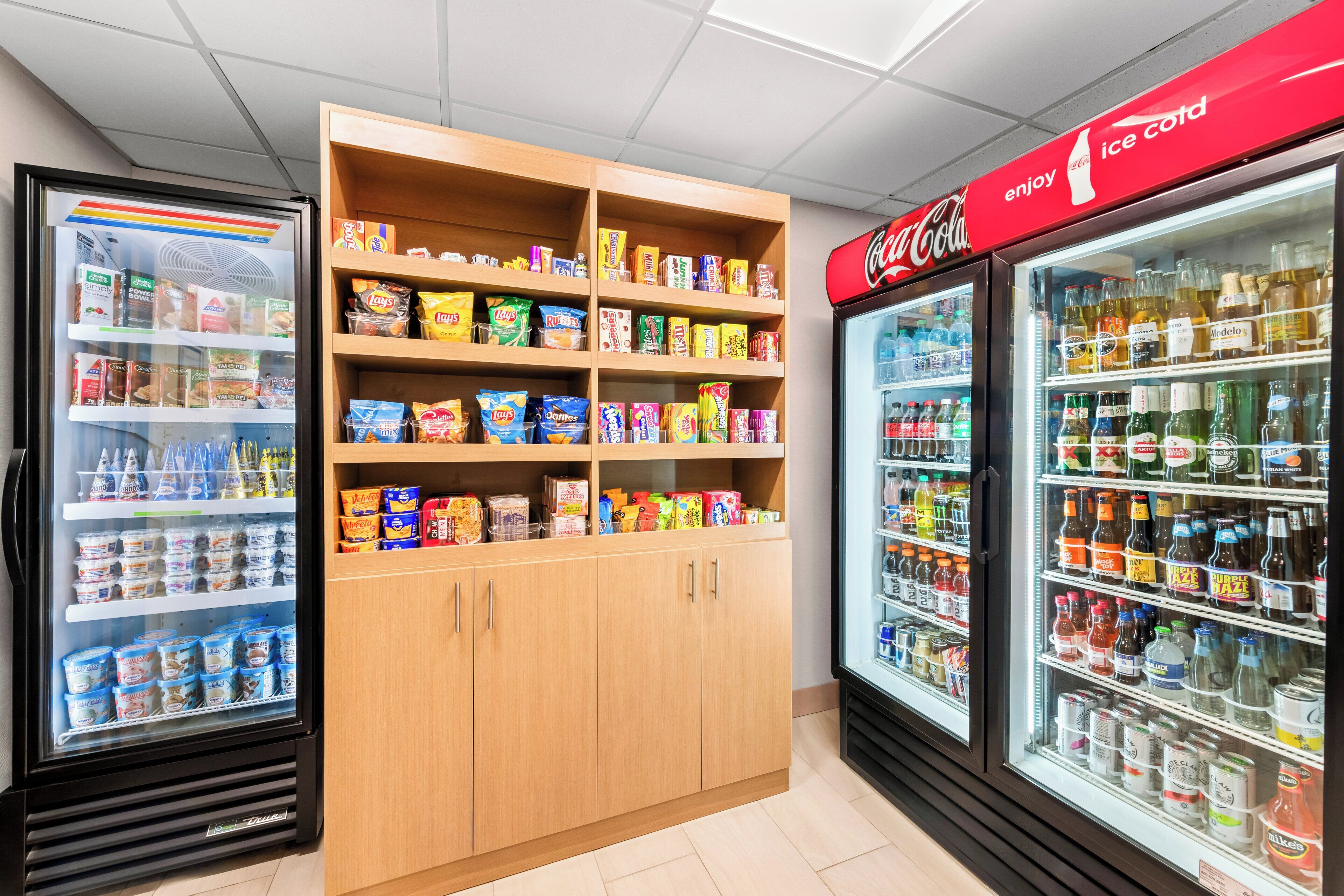 A refrigerated display case with various beverages and snacks.