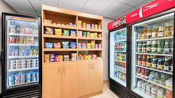 A refrigerated display case with various beverages and snacks.