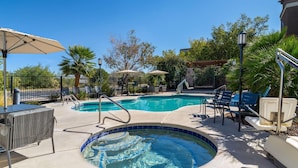 A swimming pool with a hot tub, lounge chairs, and umbrellas. - Tombstone Grand Hotel, a Baymont by Wyndham (Tombstone)