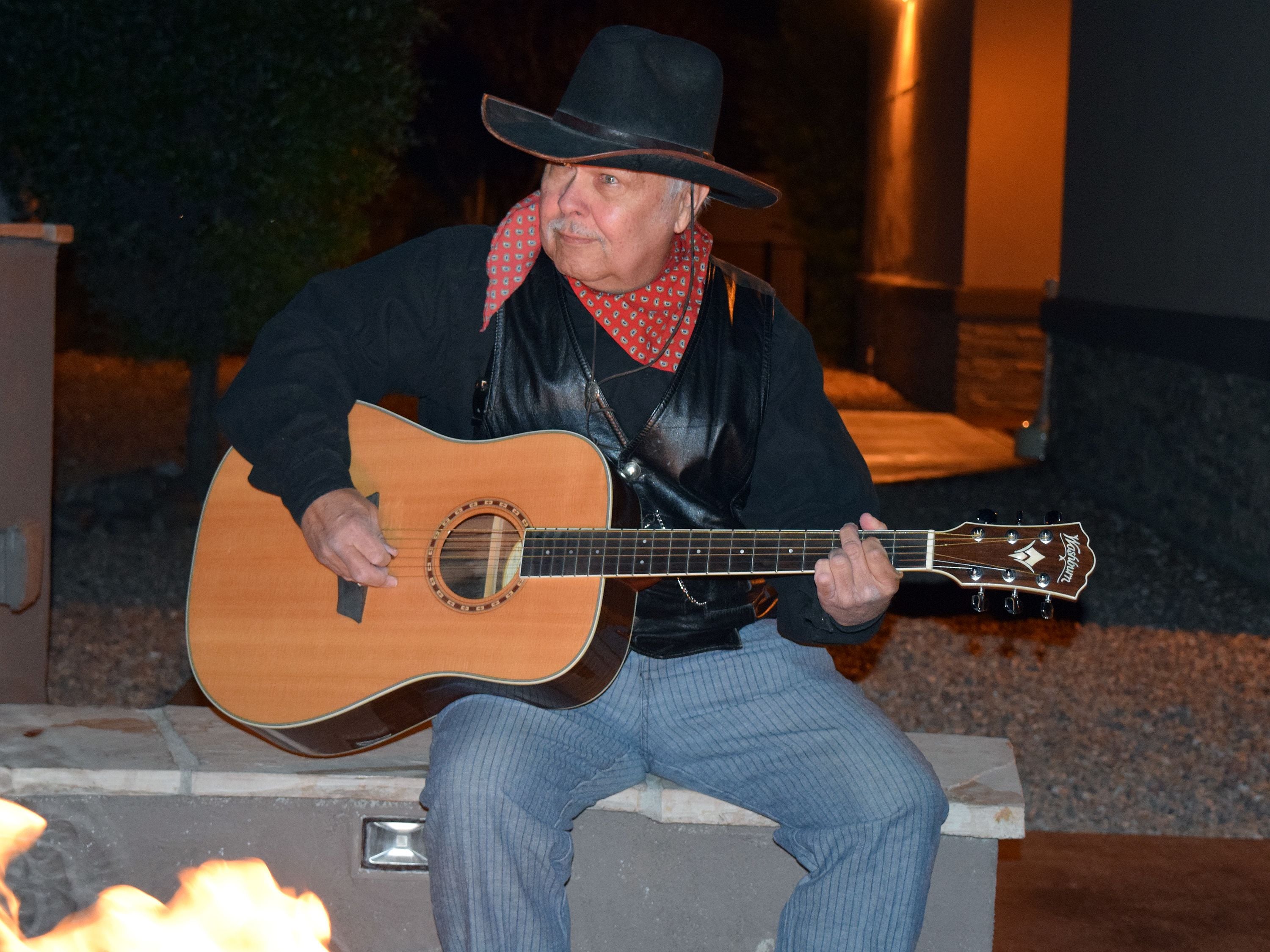 A person playing an acoustic guitar.