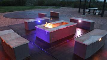 An outdoor patio area with a fire pit and seating.