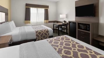A hotel room with two beds, a desk with a chair, a television, and a microwave.