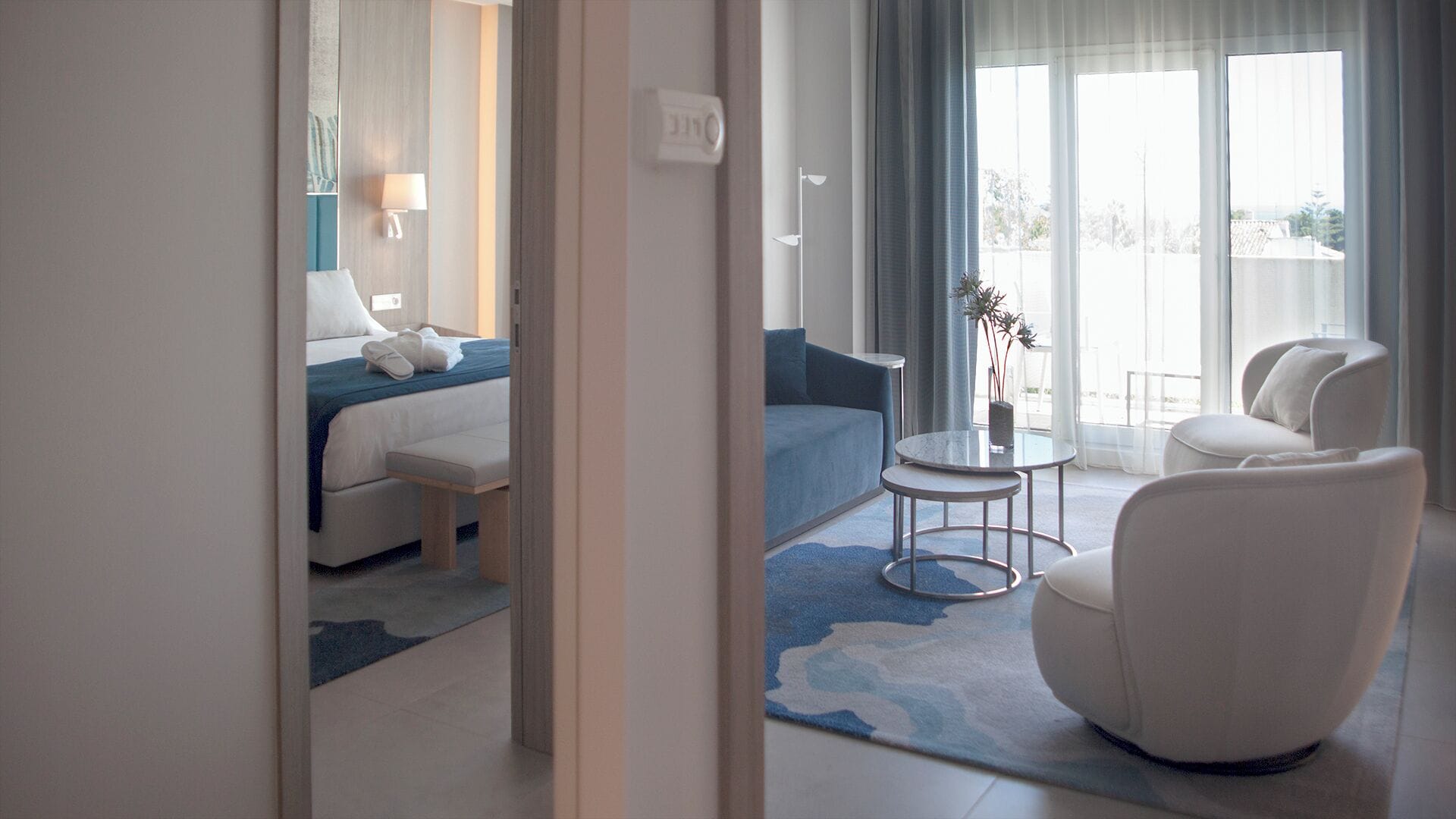 Une chambre d’hôtel avec un lit, un canapé, une table ronde et une chaise.