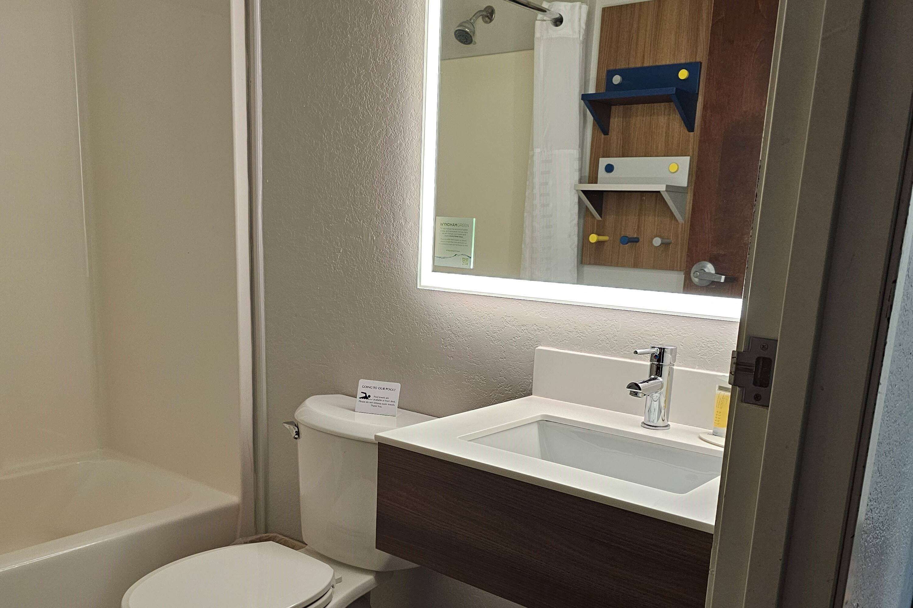 A bathroom with a bathtub, toilet, and sink.