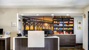 A hotel reception desk with a computer, a phone, and a sign stating the hotel is 100% smoke-free. - La Quinta Inn by Wyndham North Myrtle Beach (North Myrtle Beach)