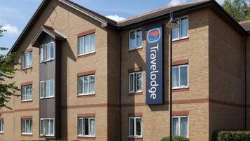 A Travelodge hotel with a brick facade, multiple windows, and a prominent Travelodge sign.