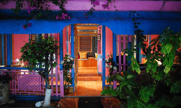 A brightly lit entrance with a tiled floor leading to a room with a bed and a nightstand. - Half Moon Blue (Scarborough)