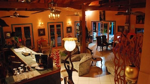 A spacious living area with a dining table, chairs, and a zebra-patterned sofa. - Half Moon Blue (Scarborough)