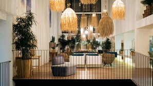 A spacious lobby with hanging rattan lamps, a central seating area, and a staircase leading to an upper level. - The Views Oasis - Family Friendly (Santa Cruz)