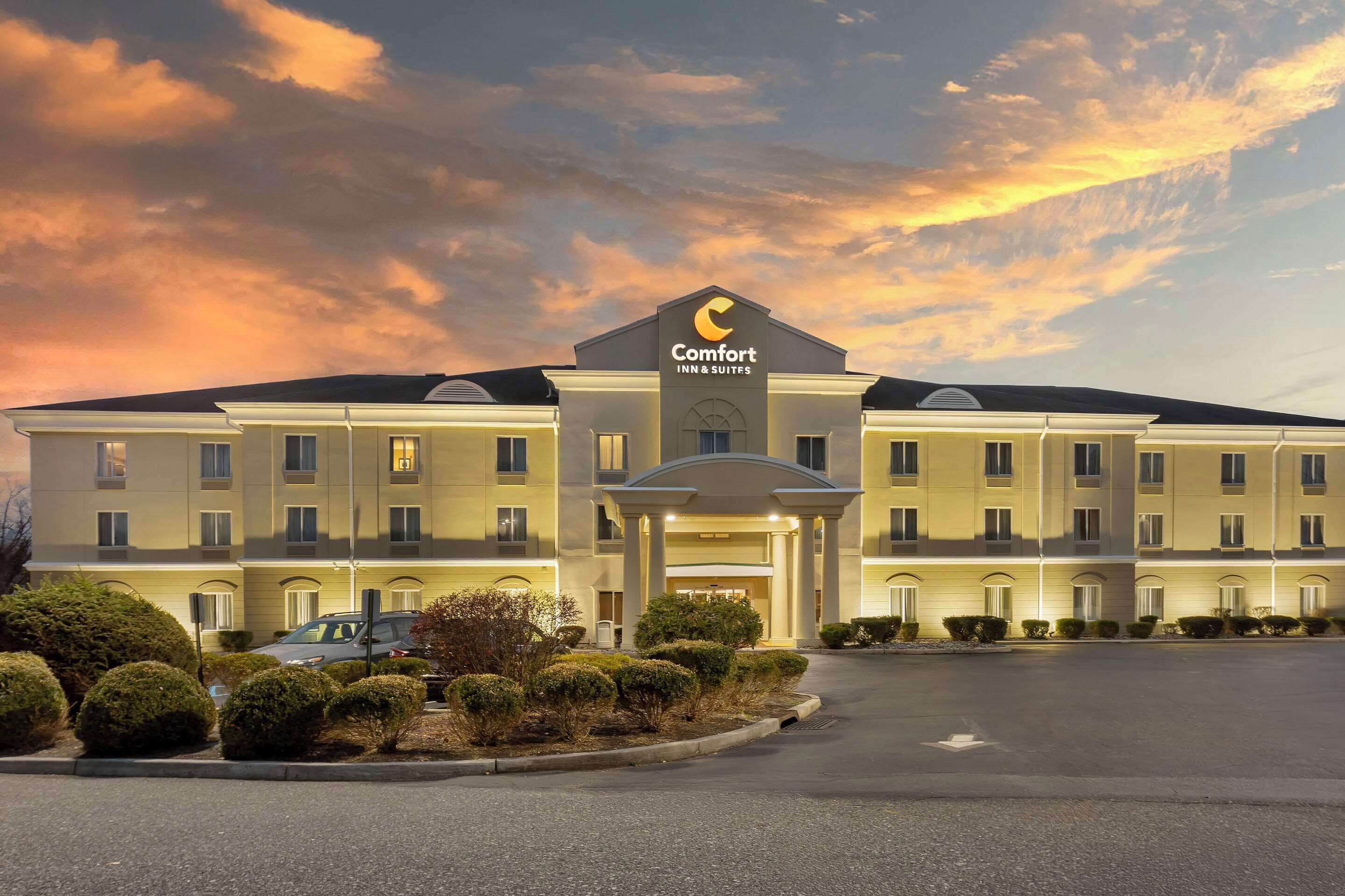 A Comfort Inn & Suites hotel with a symmetrical facade, a central entrance, and a parking lot.