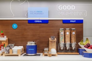A breakfast bar with cereal and fruit options, a sign asking "FEELIN' FRESH THIS MORNING?", and a "GOOD MORNING" sign. - Holiday Inn Express Biddeford by IHG (Biddeford)