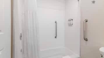 A bathroom with a bathtub, a shower, and a toilet.