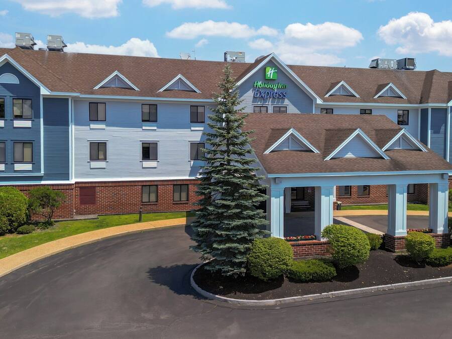 A Holiday Inn Express hotel with a covered entrance, multiple windows, and a brick facade.