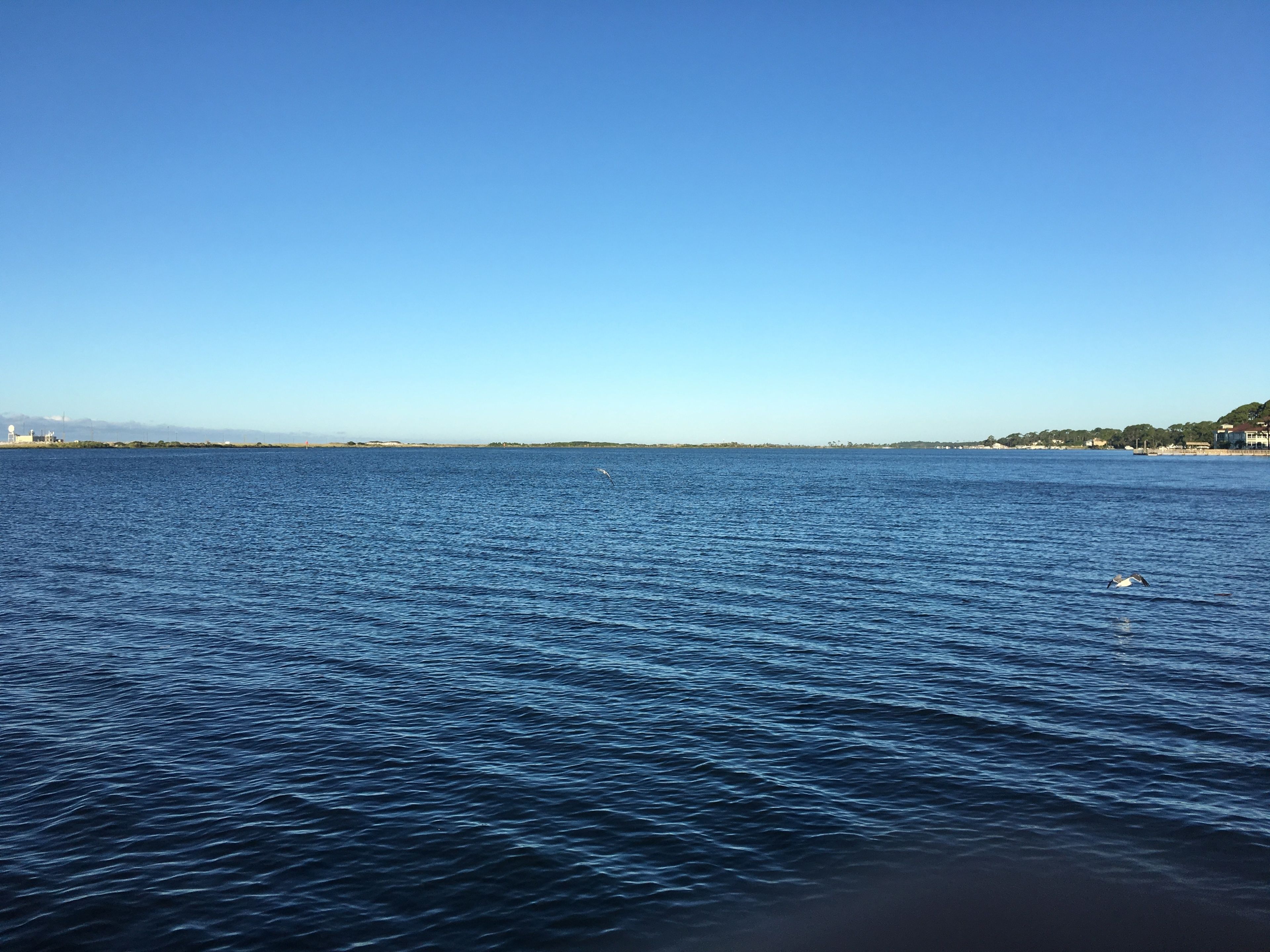A calm sea with a clear sky.