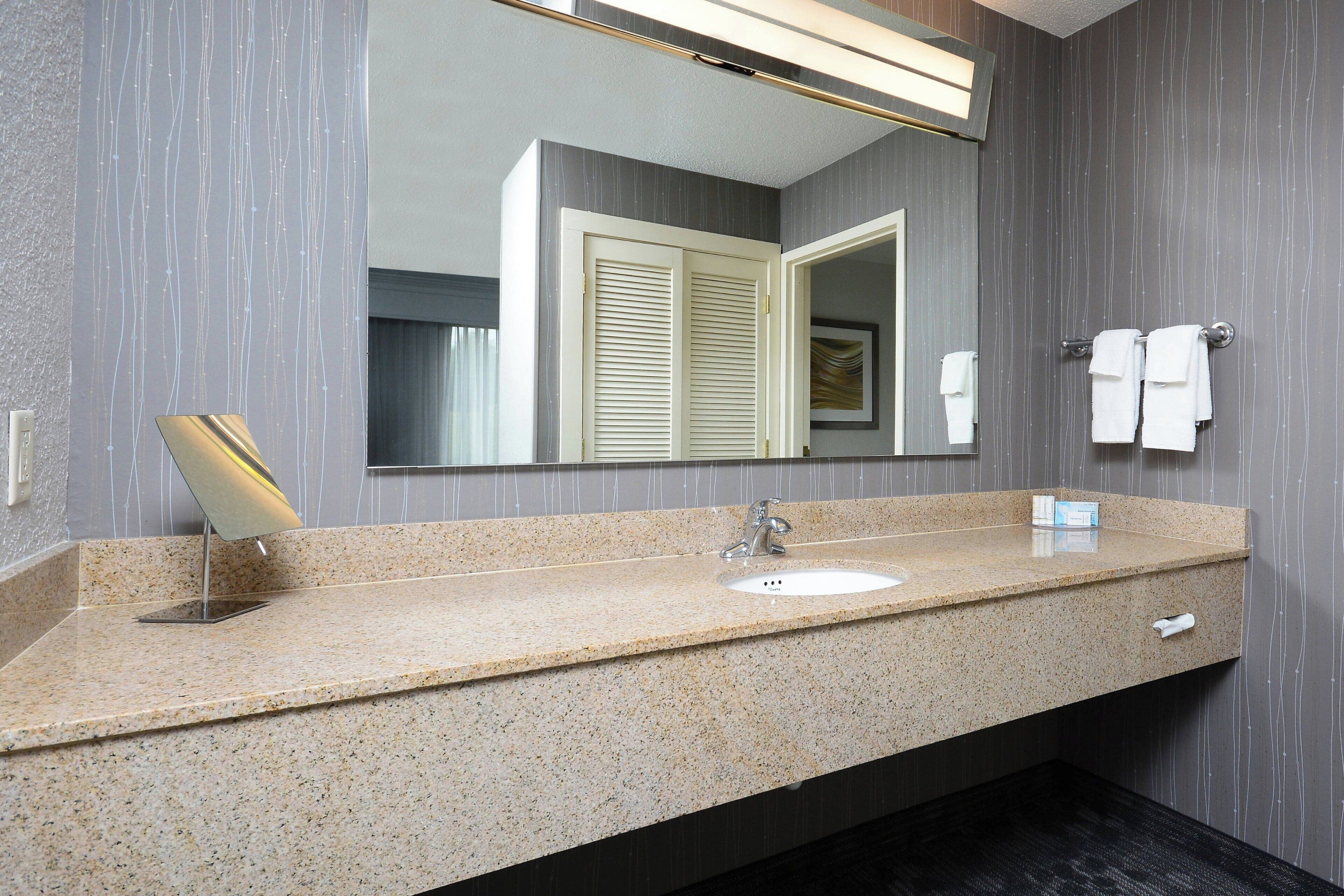 designer toiletries, hair dryer, towels, soap