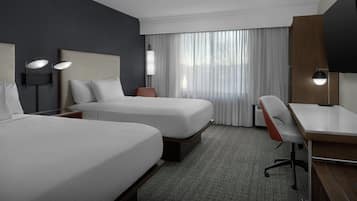 Premium bedding, desk, laptop workspace, blackout drapes