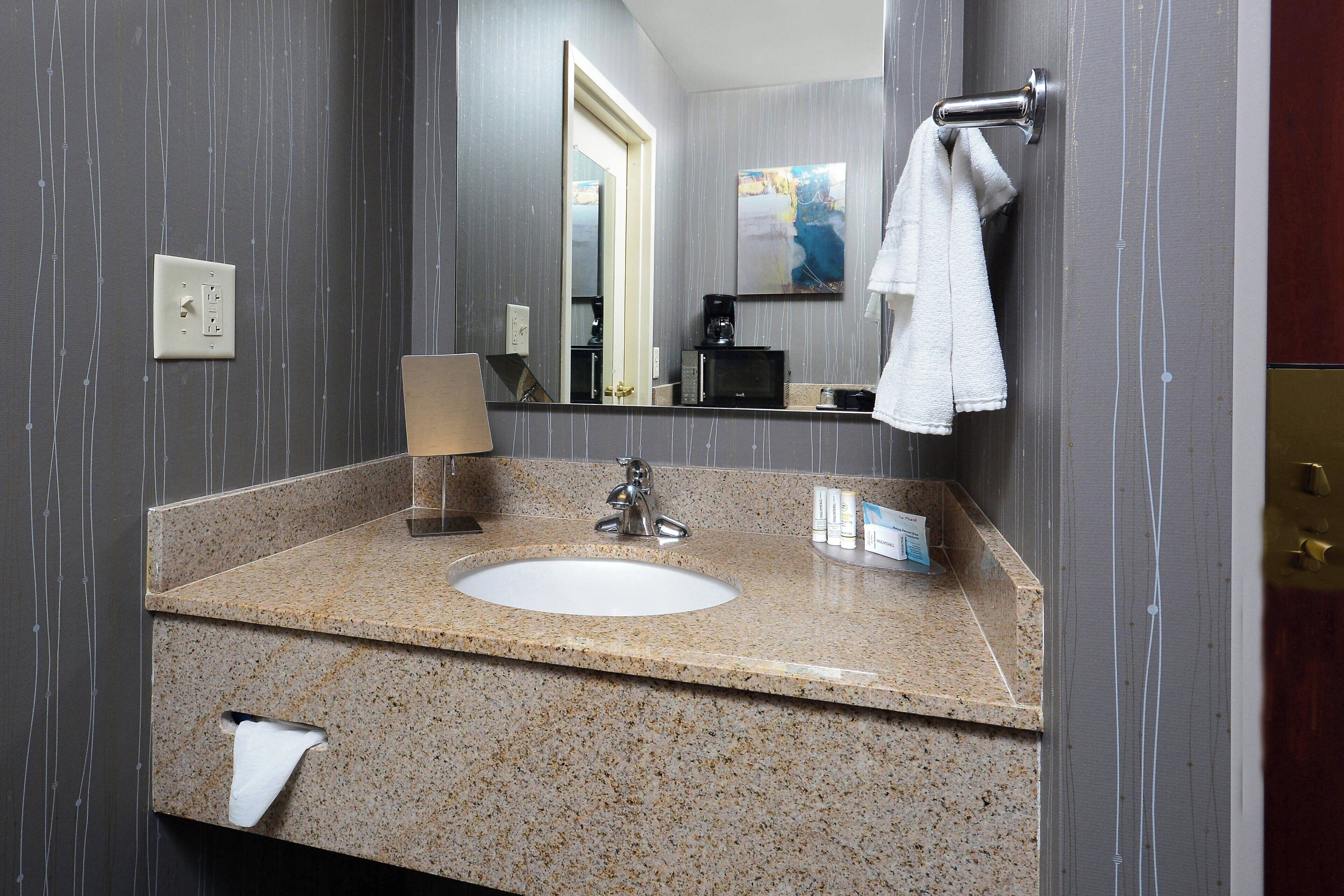 designer toiletries, hair dryer, towels, soap