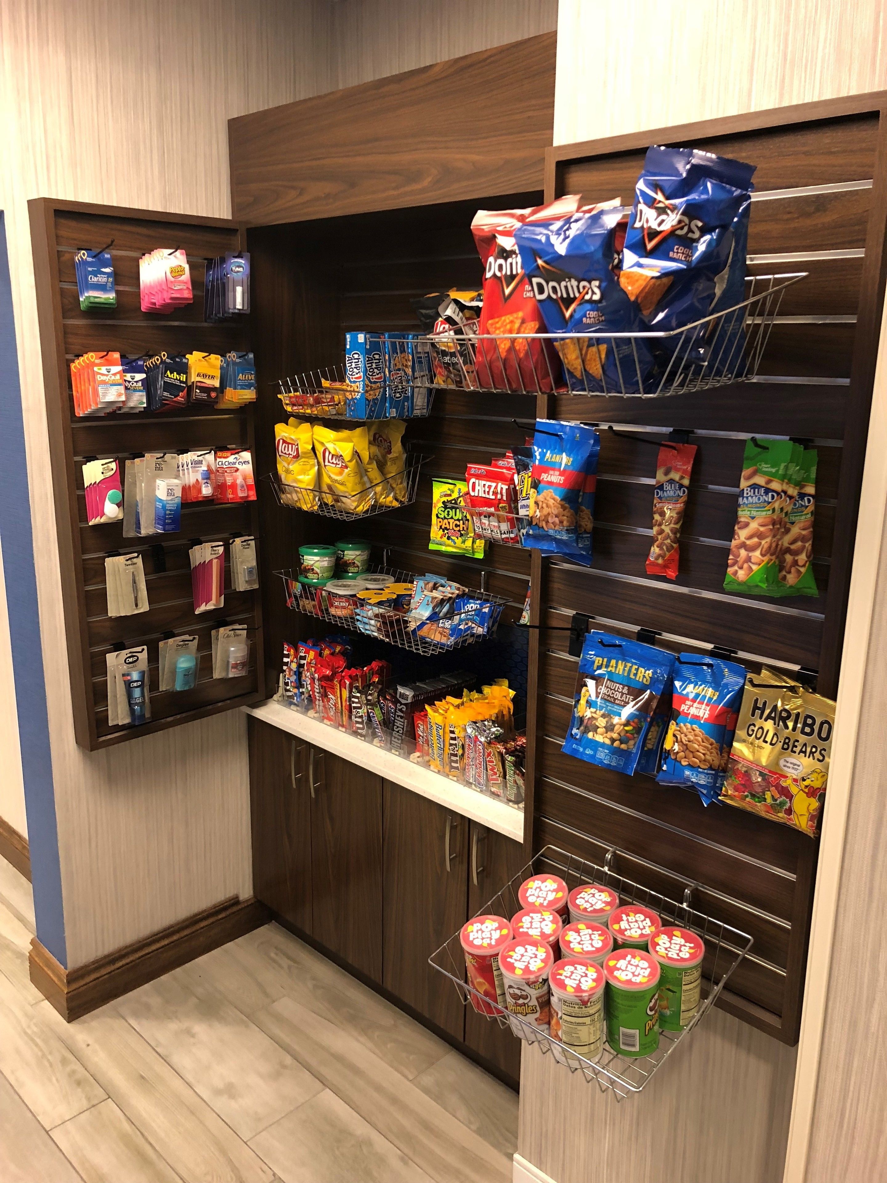A snack and beverage display in a store with various snacks and drinks.