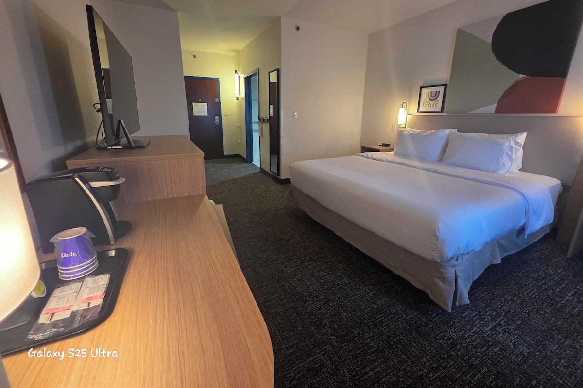 Premium bedding, desk, laptop workspace, blackout drapes