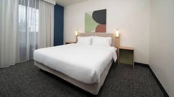 Premium bedding, desk, laptop workspace, blackout curtains