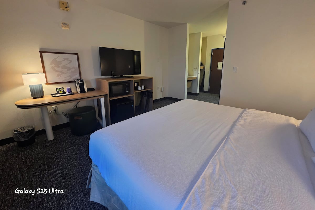 Premium bedding, desk, laptop workspace, blackout drapes