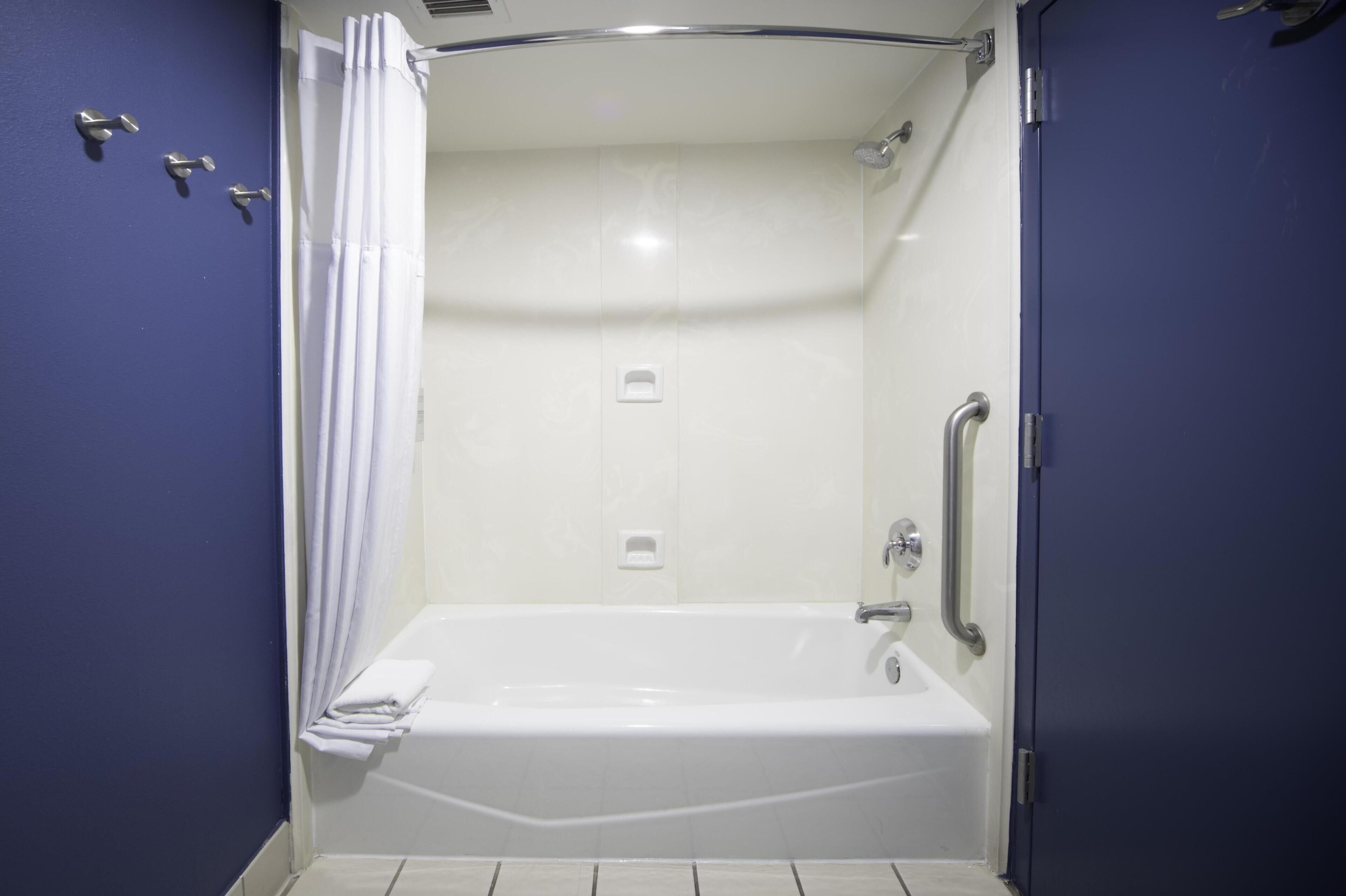 A bathroom with a bathtub, a shower, and a toilet.
