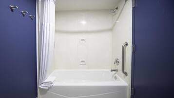 A bathroom with a bathtub, a shower, and a toilet.