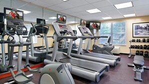 A gym with treadmills, elliptical machines, and a bench. - TownePlace Suites by Marriott Knoxville Cedar Bluff (Knoxville)