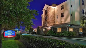 TownePlace Suites by Marriott with a stone facade, a swimming pool, and well-lit surroundings. - TownePlace Suites by Marriott Knoxville Cedar Bluff (Knoxville)
