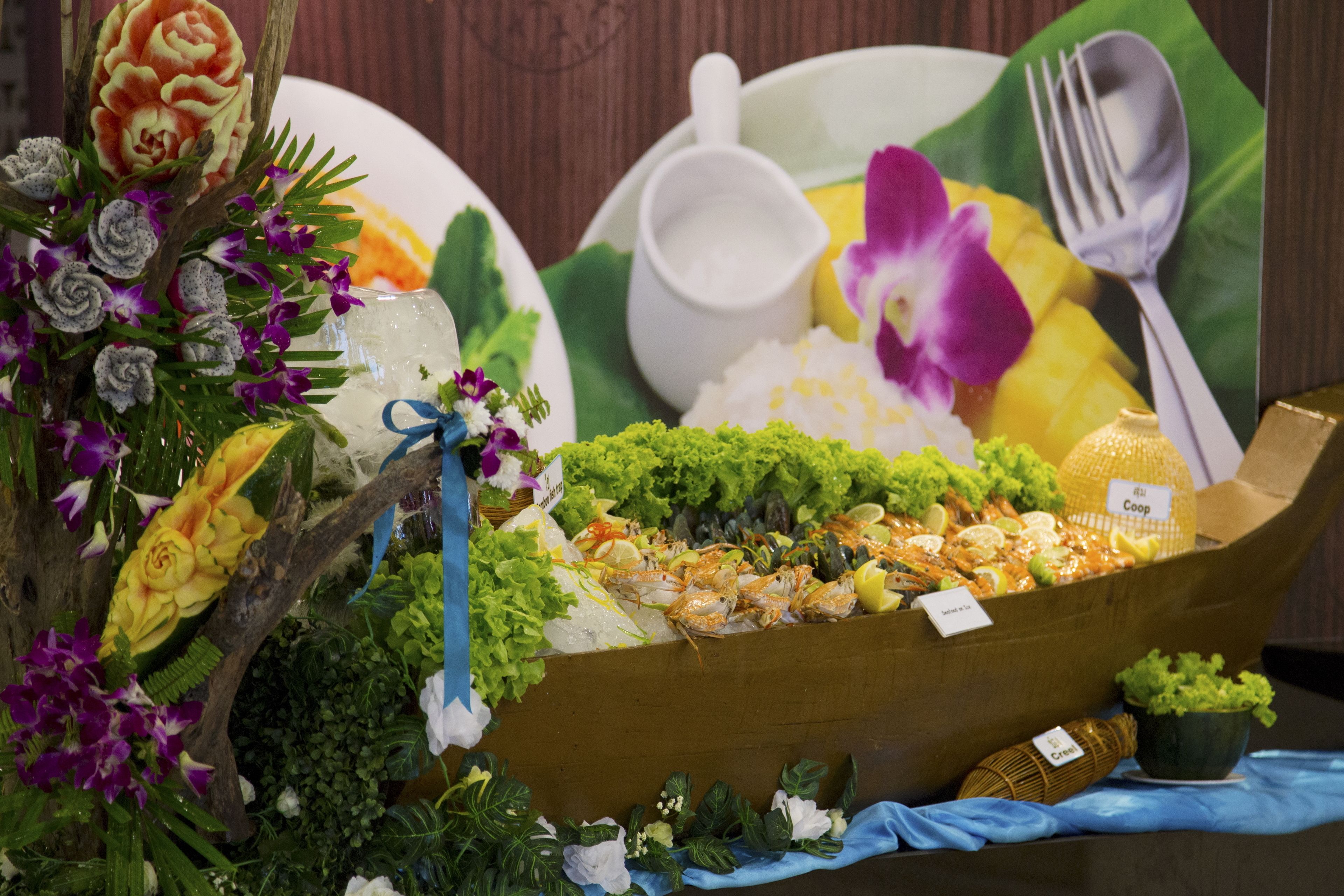 A seafood display with a variety of dishes, including shrimp and mussels, arranged on ice.