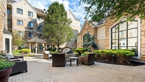 A courtyard with outdoor seating, a fire pit, and a gazebo. - Staybridge Suites Cincinnati North by IHG (West Chester)