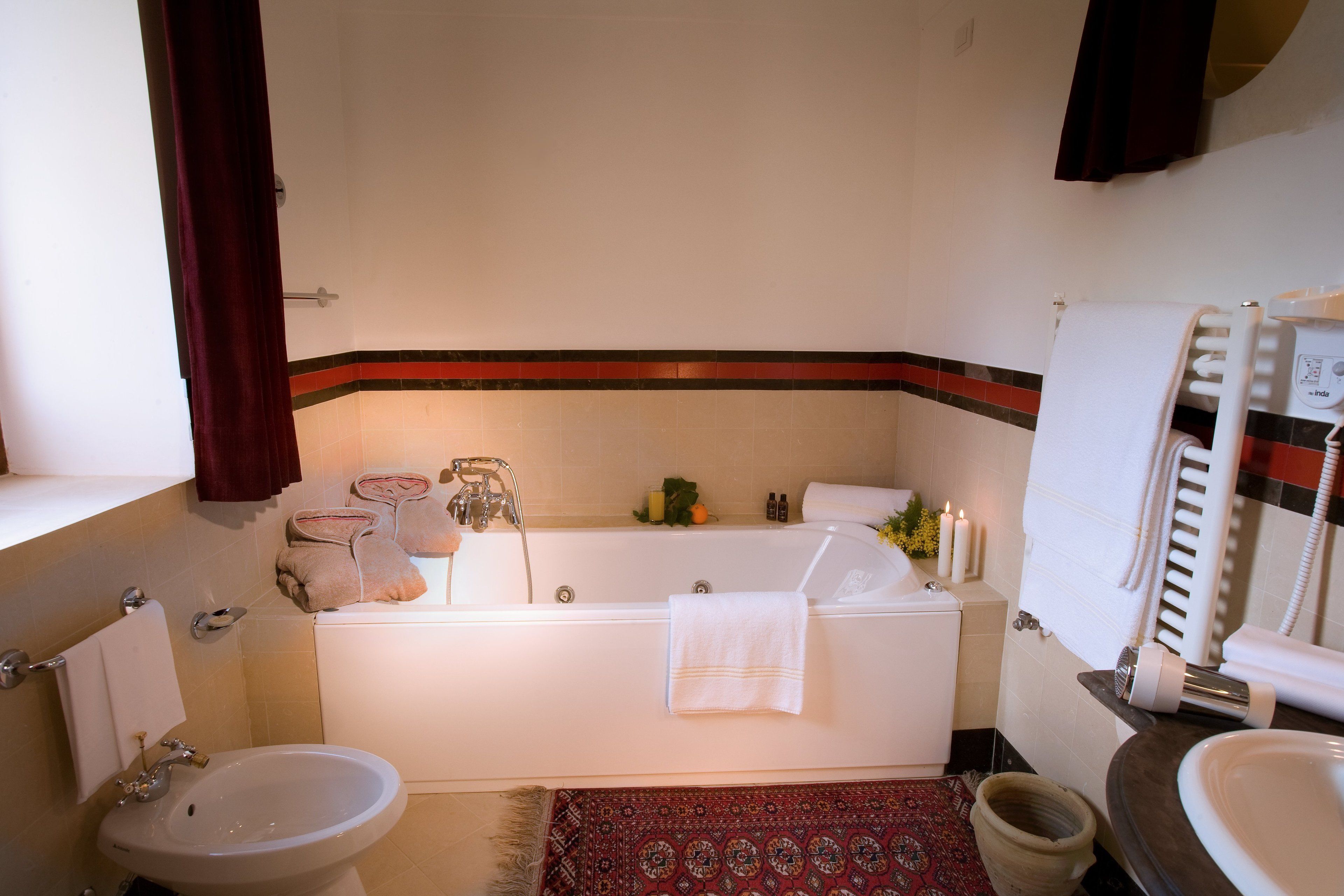 A bathroom with a bathtub, a sink, and a toilet.