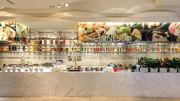 A food display area with a variety of packaged goods and a 'CHINESE' sign above.