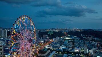 A cityscape with a prominent Ferris wheel and various buildings.