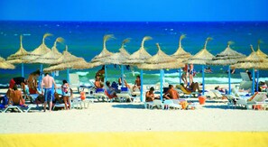 On the beach, sun loungers, beach umbrellas