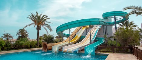 A water park with multiple slides and a pool.