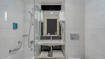 A modern bathroom with a glass shower enclosure, a white sink, and a toilet.
