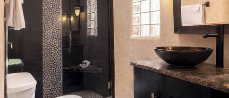 Un baño moderno con inodoro, lavabo y ducha.
