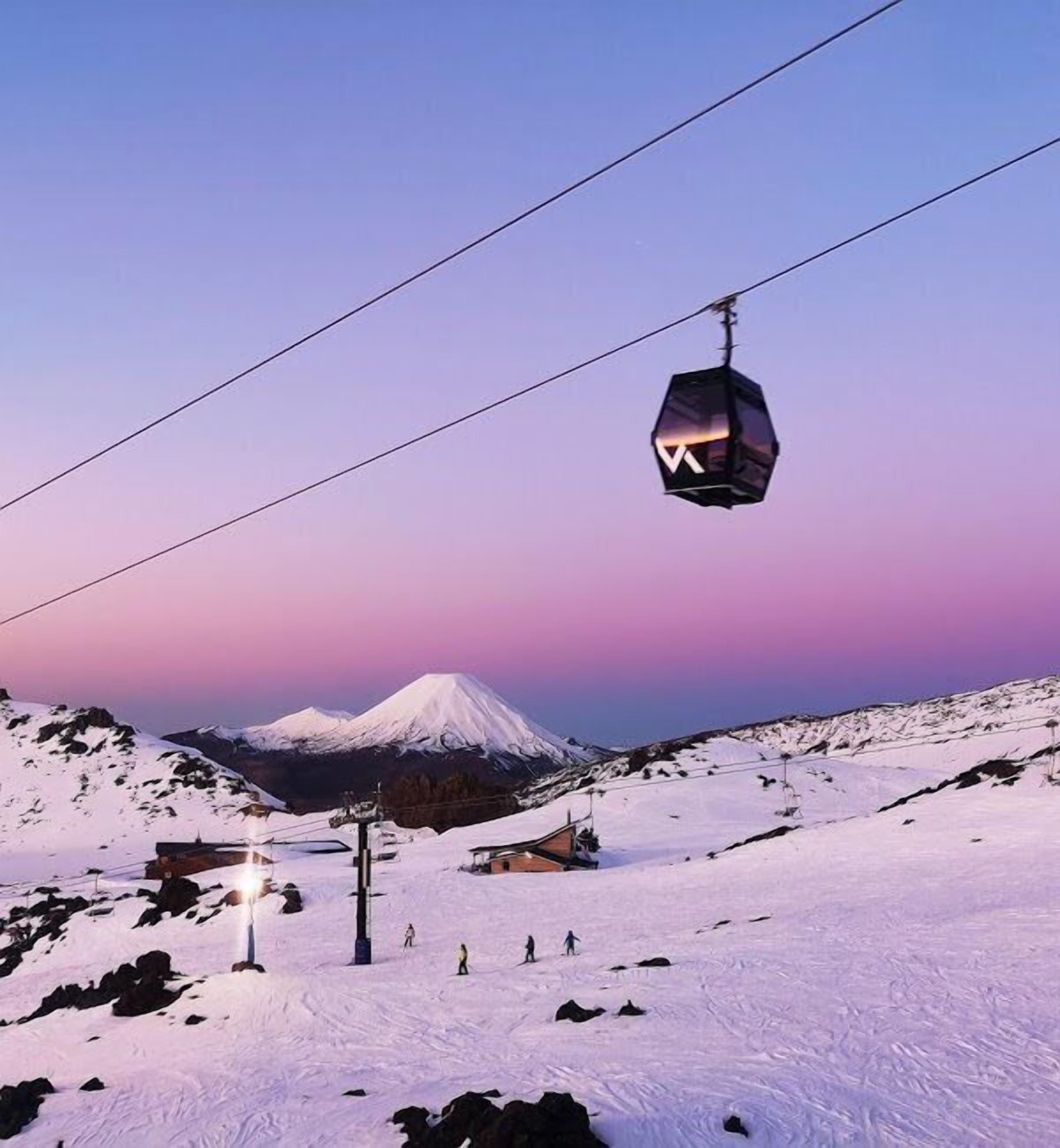 A cable car system with a mountain in the background.