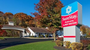 A hotel sign with a blue and red color scheme, indicating it is a SureStay Plus Hotel by Best Western. - SureStay Plus Hotel by Best Western Highland Poughkeepsie (Highland)